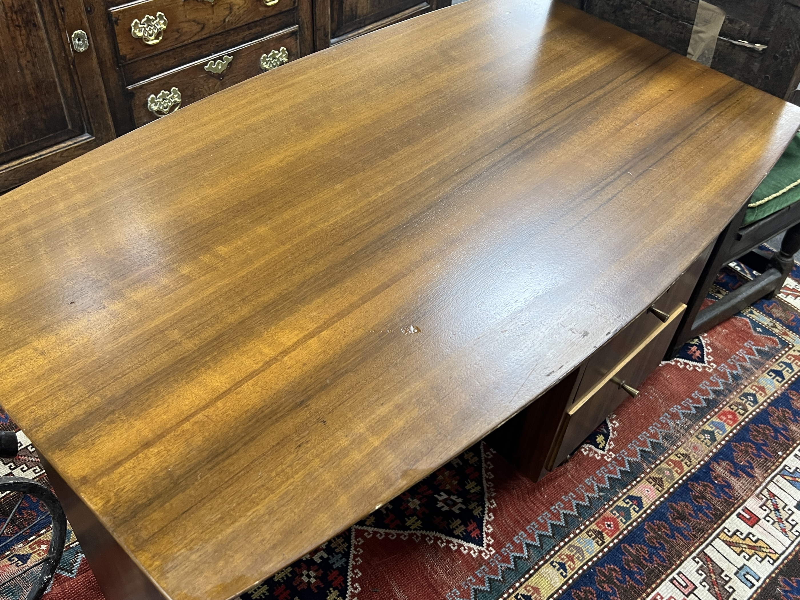 A mid century walnut desk, width 108cm, depth 64cm, height 75cm